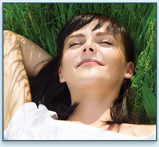 woman lying in grass with eyes closed