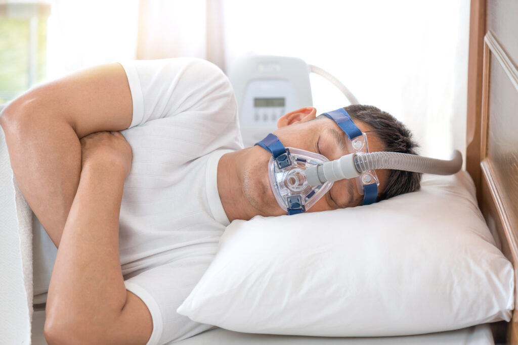 Man Sleeping with Sleep Apnea Machine
