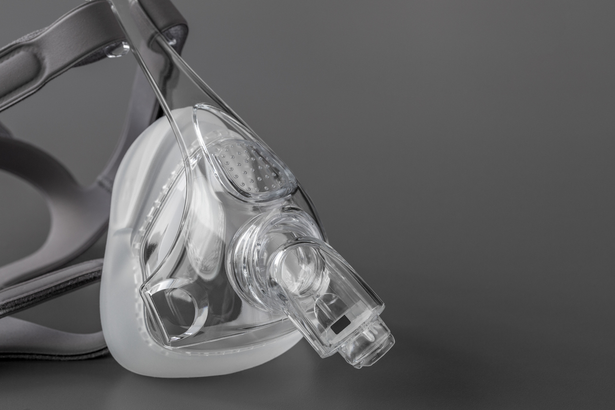 Sleep apnea CPAP mask on the grey background